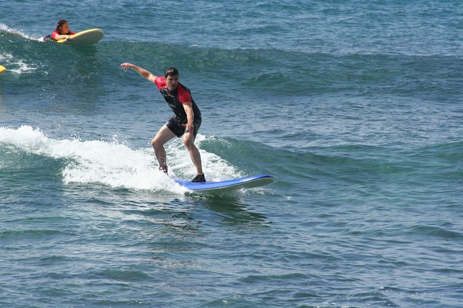 Po'ipu Surf Lesson - Taking the board into Poipu’s warm water
